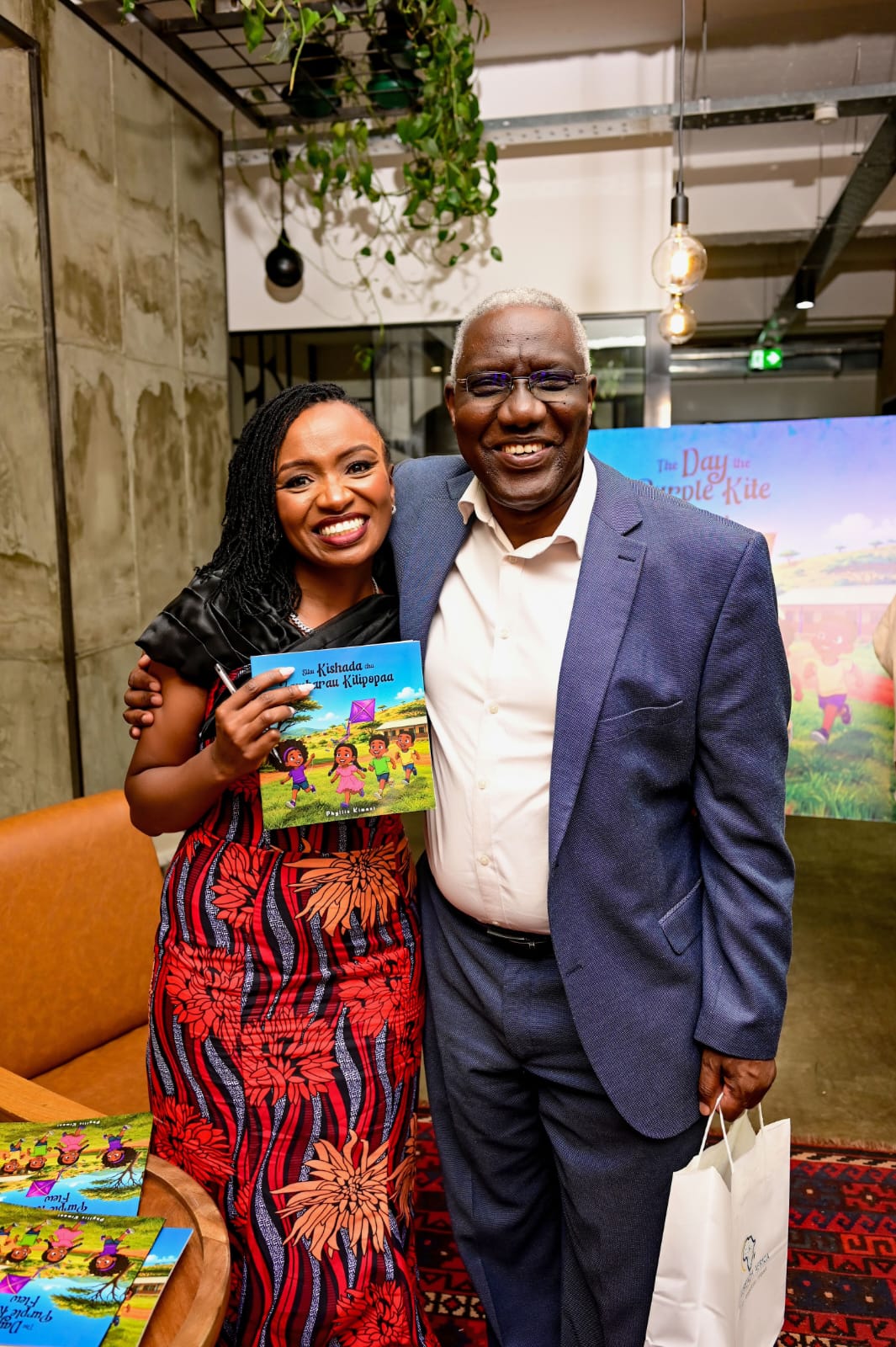 Dr Phyllis Kimani with a guest holding copies of The Day the Purple Kite Flew at the book launch.