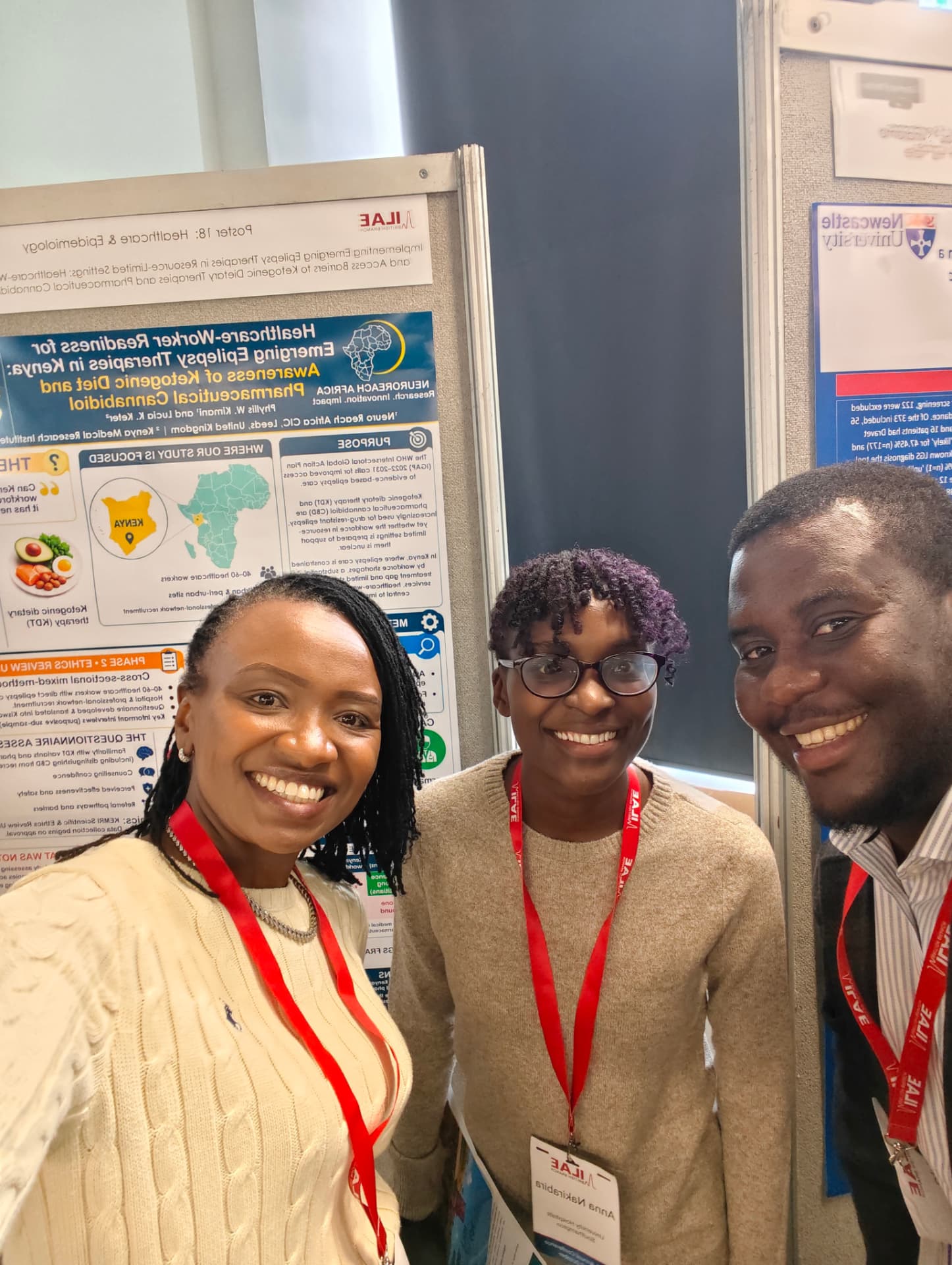 A selfie with delegates in front of the poster