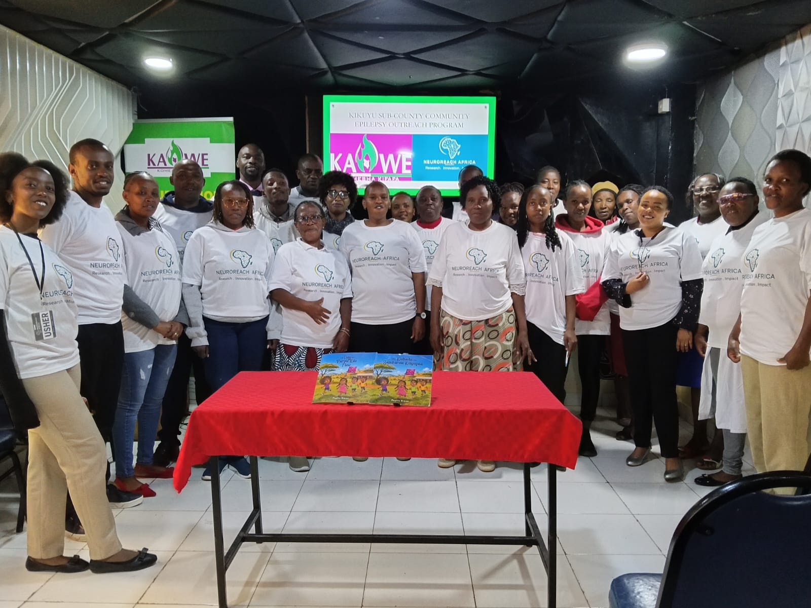 Community Health Promoters and volunteers trained as NeuroReach Africa Epilepsy Champions in Kikuyu Sub-County, standing together with the NeuroReach Africa and KAWE teams.