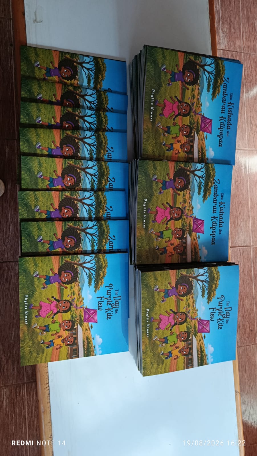 Neatly arranged copies of The Day the Purple Kite Flew and the Kiswahili edition prepared for distribution.