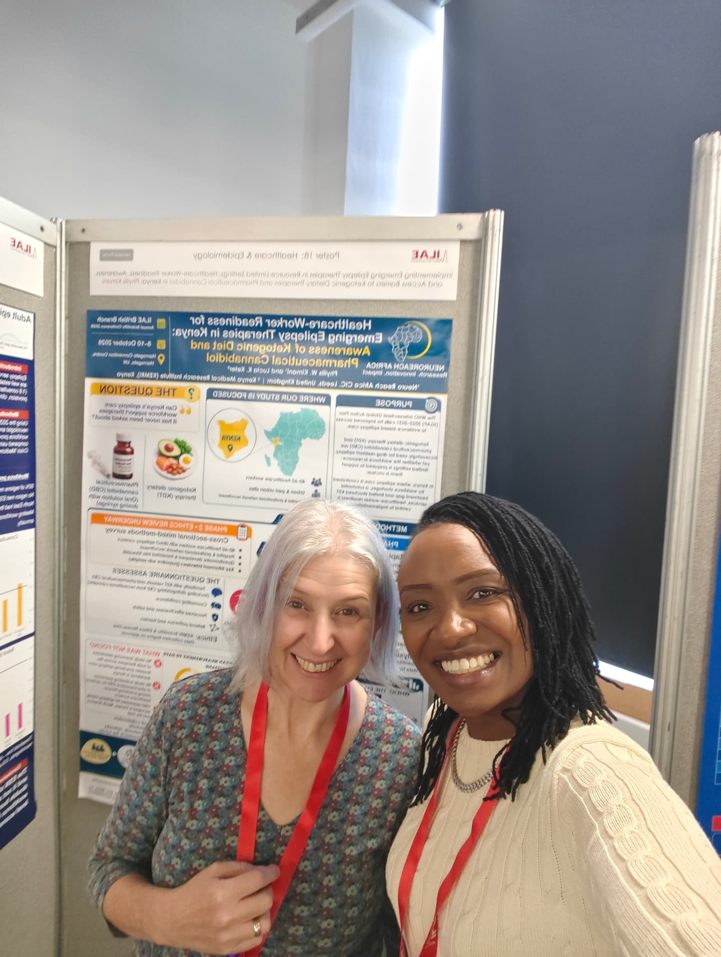 Phyllis with a delegate in front of her poster