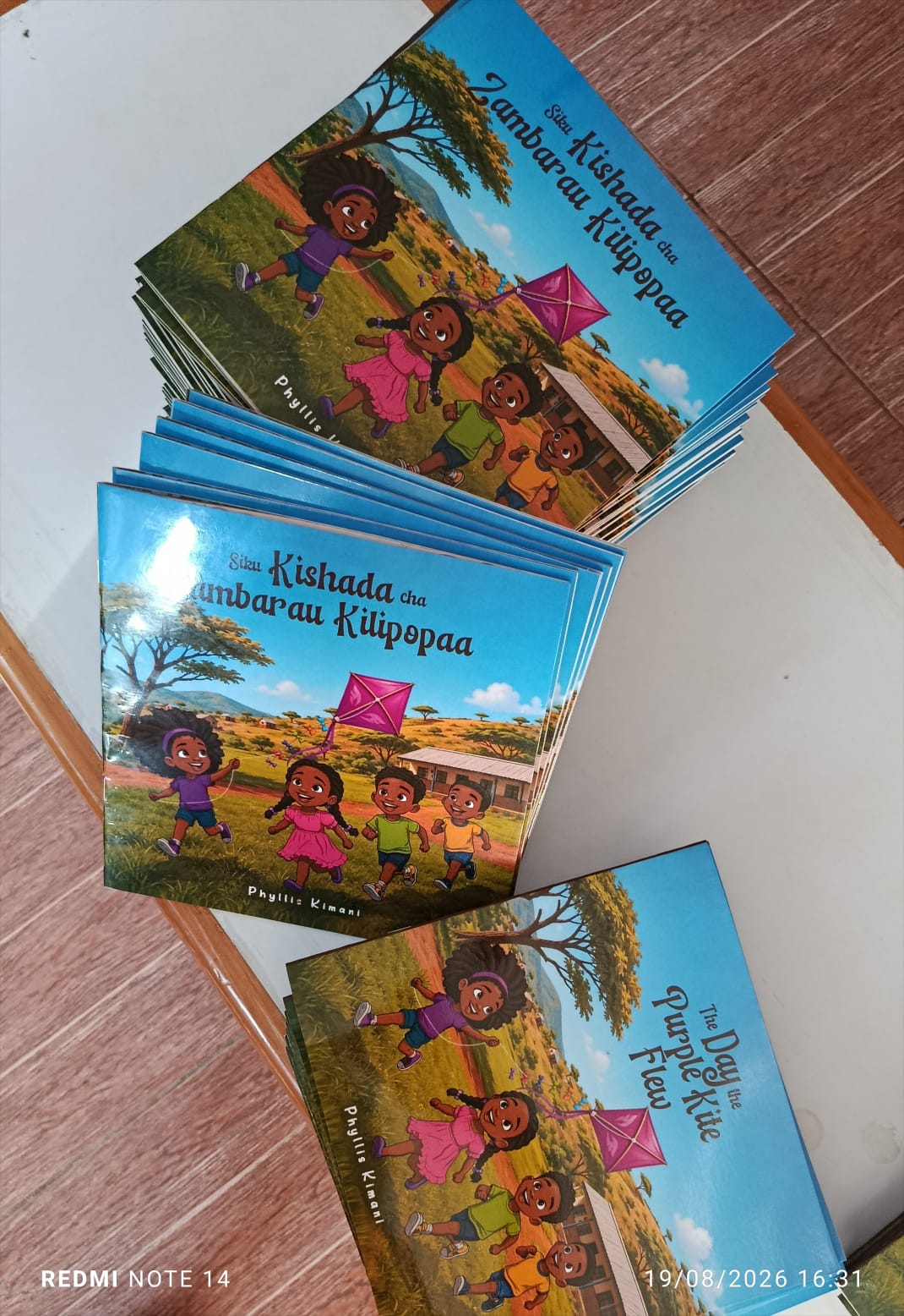 English, Kiswahili and Shona editions of The Day the Purple Kite Flew stacked together