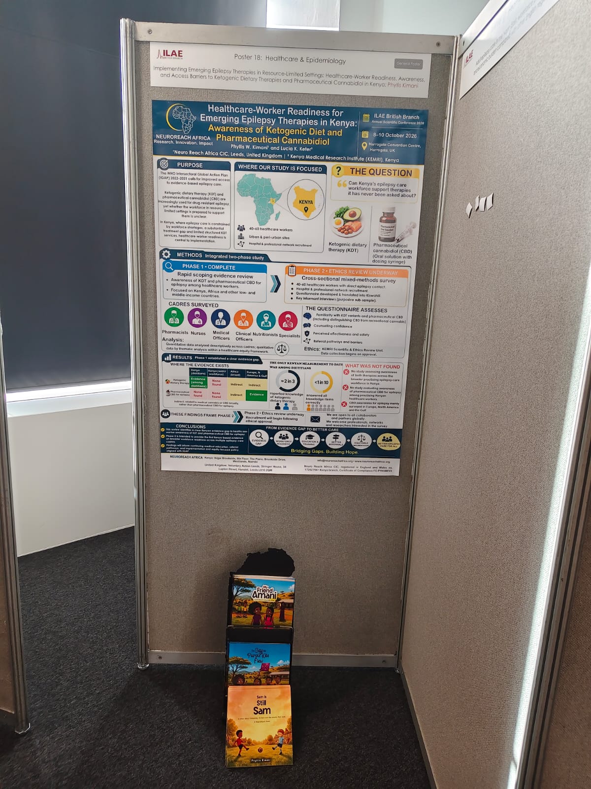 The poster on healthcare-worker readiness for emerging epilepsy therapies in Kenya, with the Friends Series books below